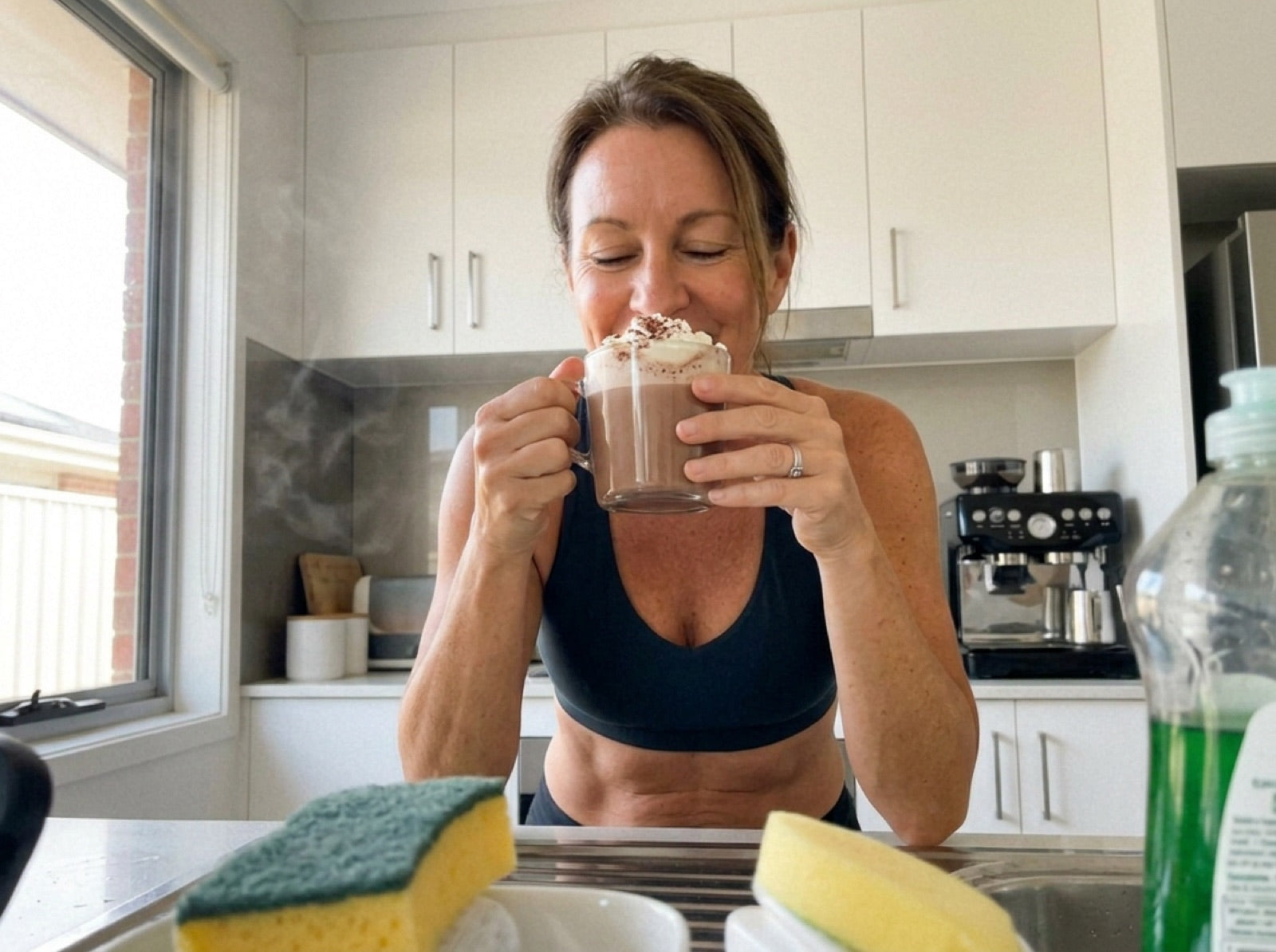 Woman enjoying a cup of chocolate in her kitchen
