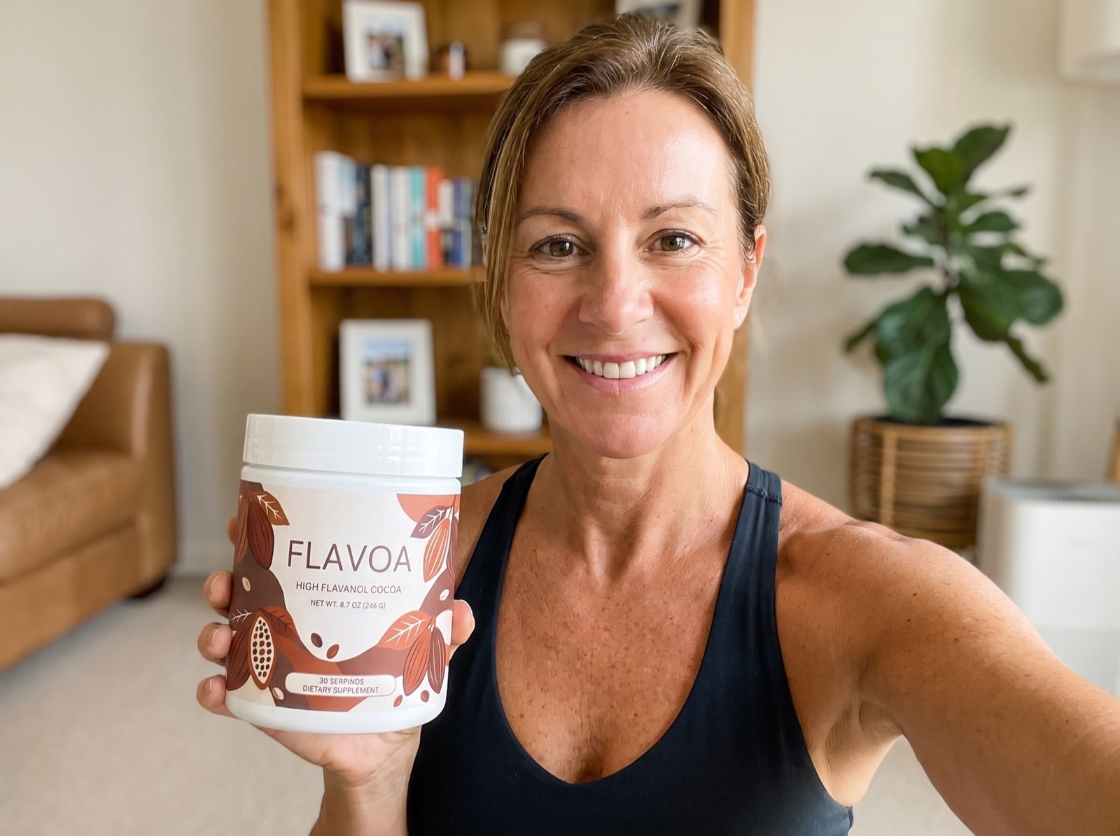 Reviewer holding her jar of Flavoa high flavanol cocoa