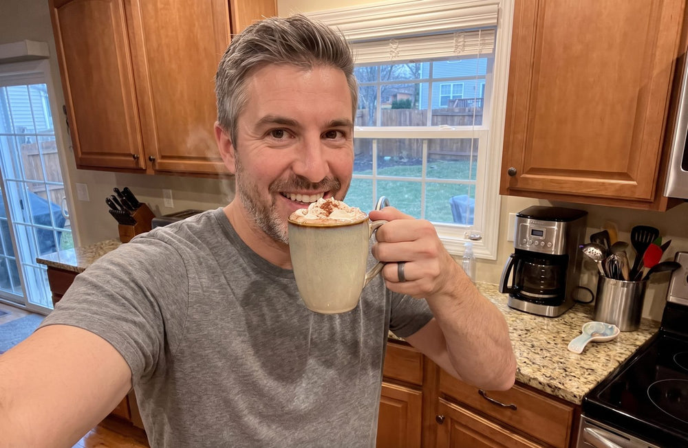 Man enjoying a cup of chocolate in his kitchen