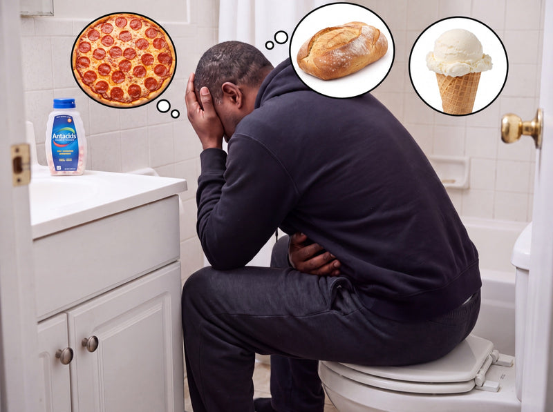 Man sitting on the toilet holding his head, thinking about pizza, bread and ice cream